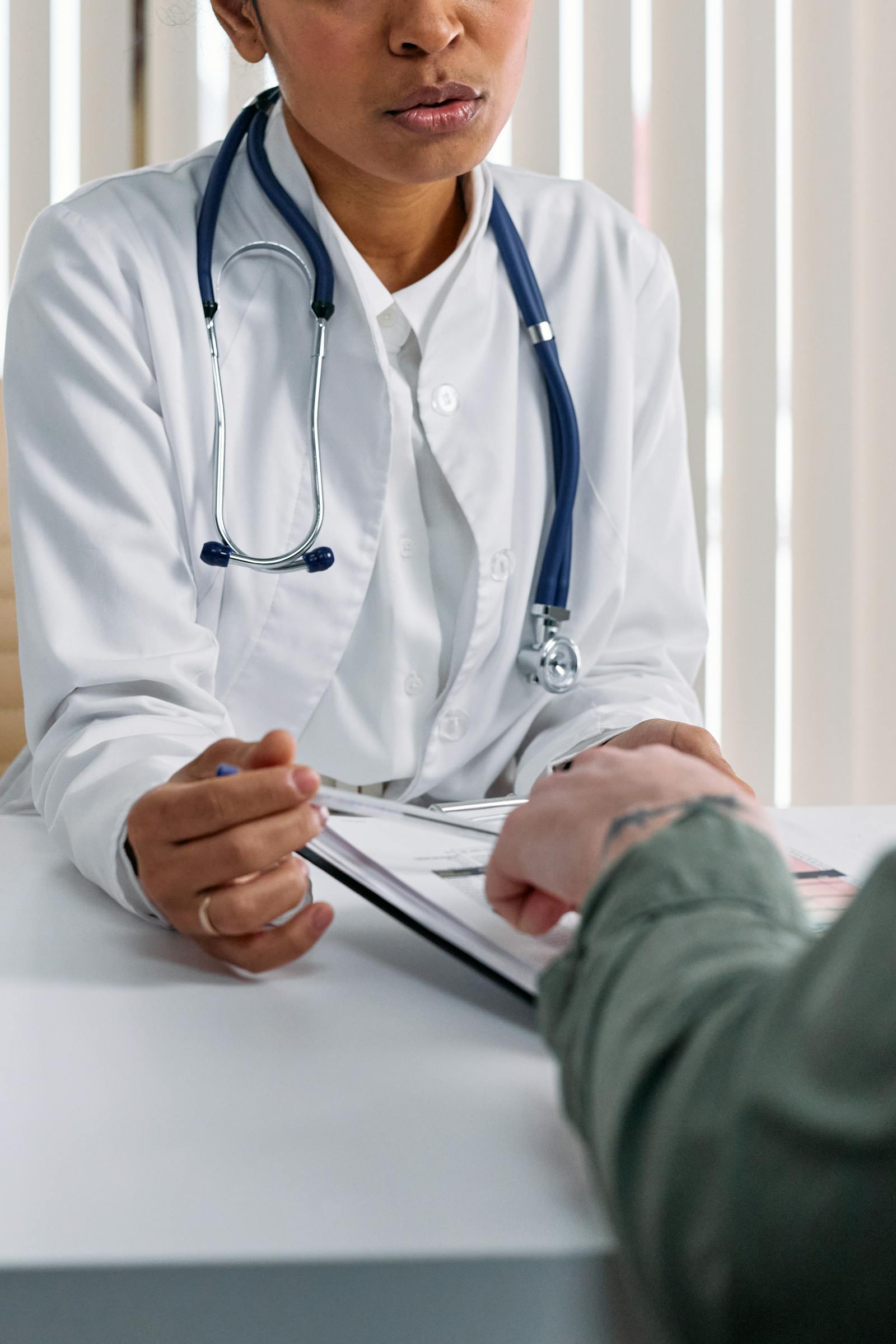 A clinician walks a patient through a printed treatment plan and cost summary